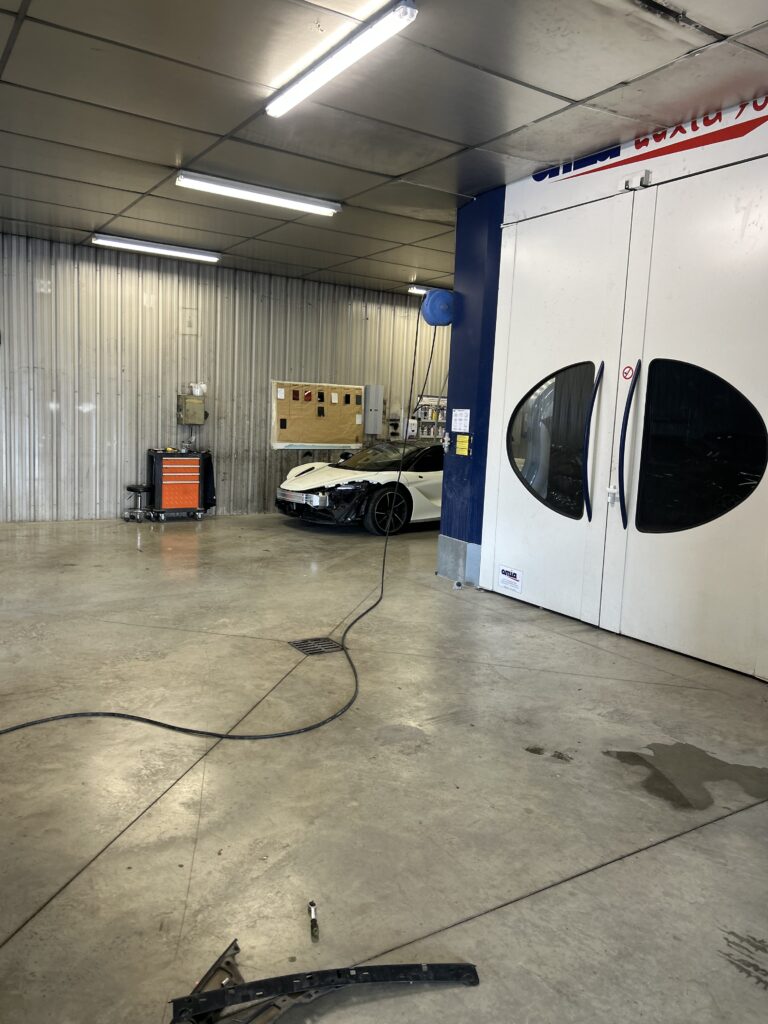 Travail de peinture automobile en cabine.